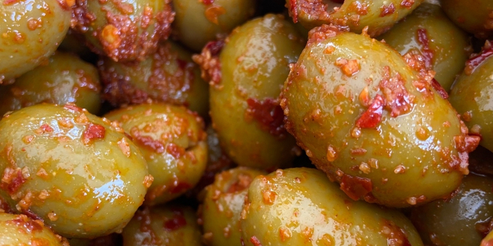 Image shows seasoned olives