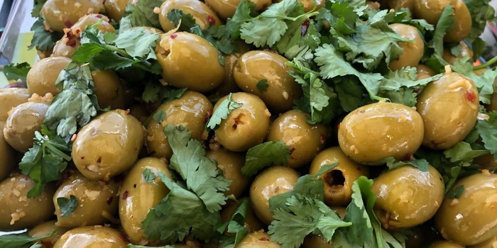Image shows seasoned green olives